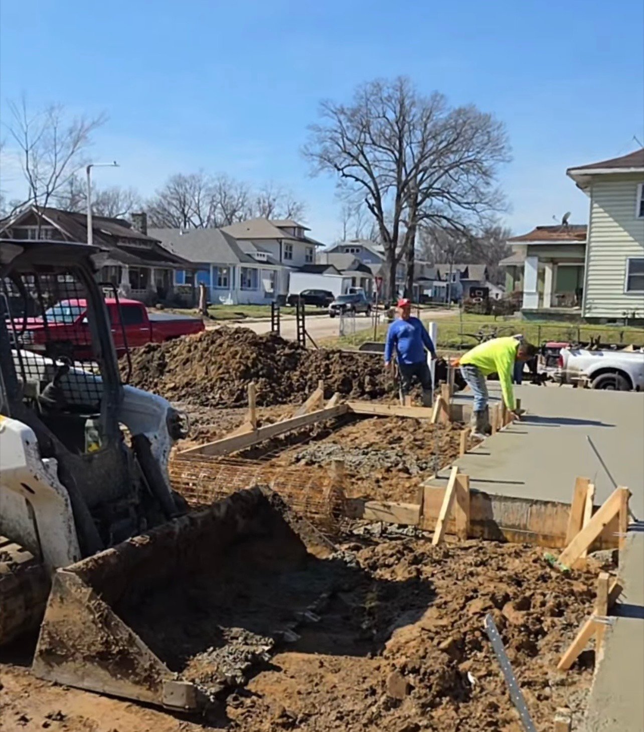 Crew smoothing the fresh concrete slab