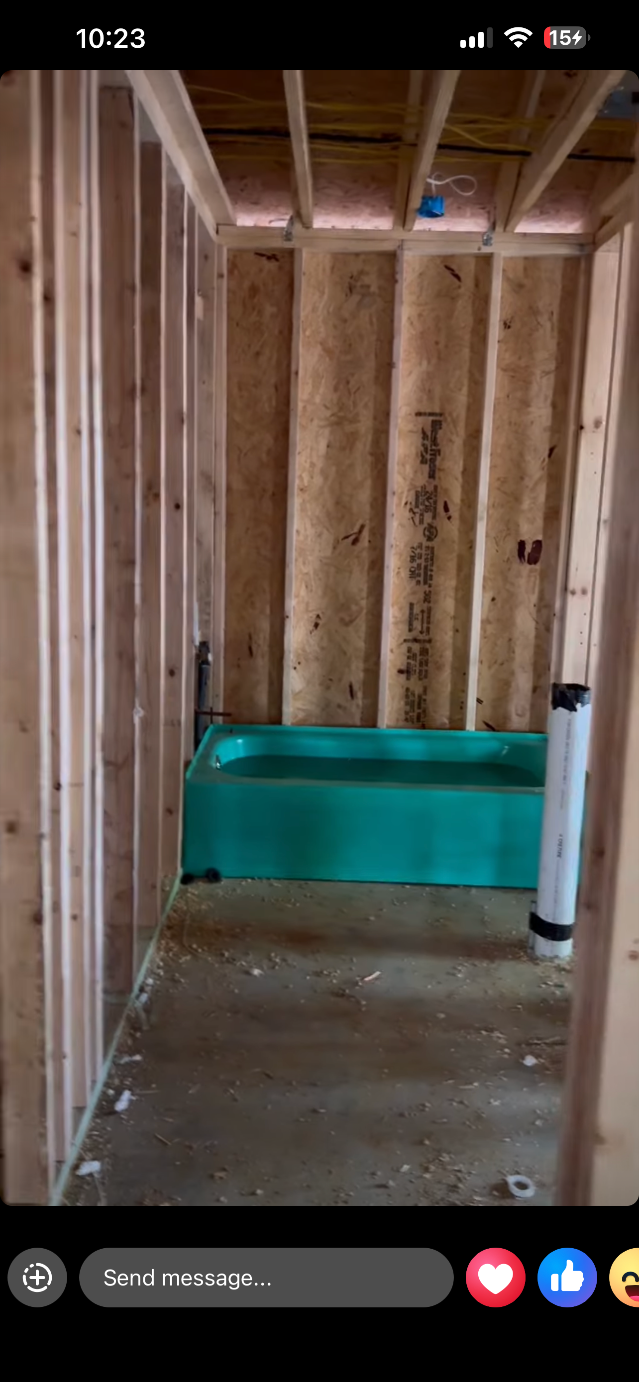 Bathroom framing with tub set — rough-in complete