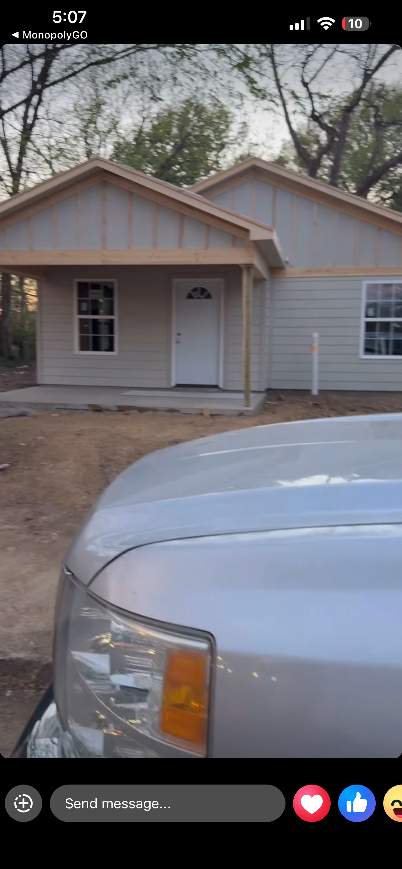 Near-complete front — gray board-and-batten siding, covered porch